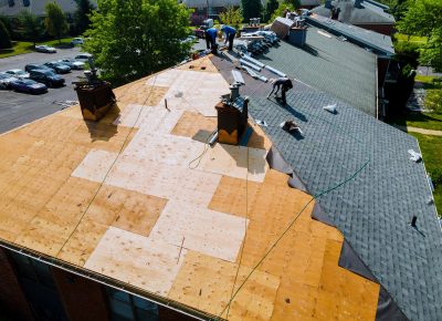 Roof repairs old roof replacement with new shingles of an apartment building